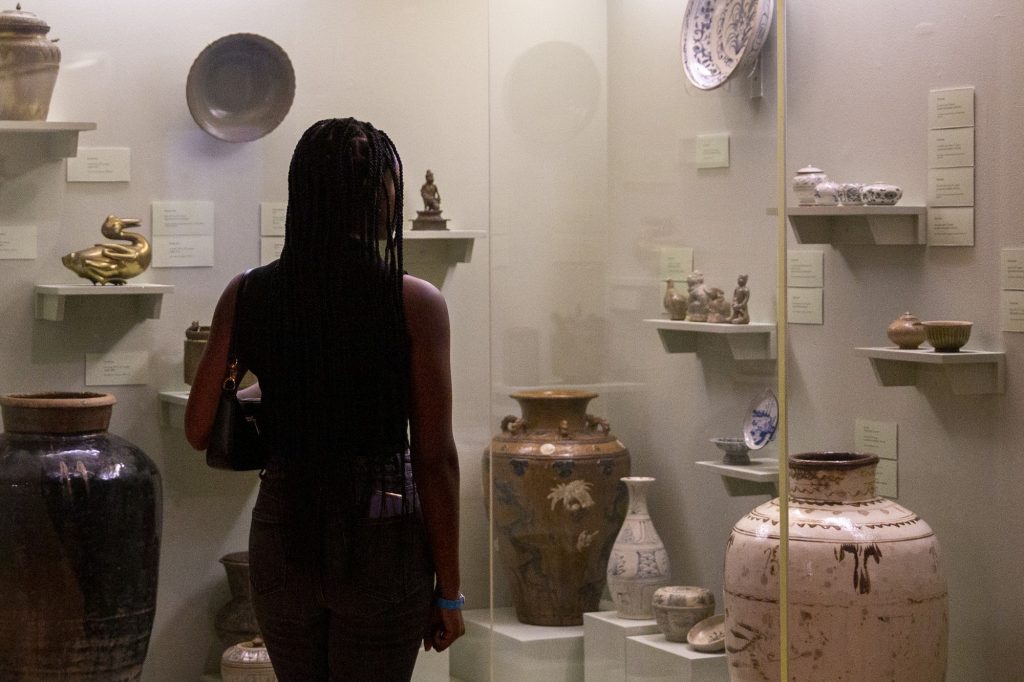 A woman admires artifacts at the Lowe Art Museum’s After Hours Exhibit on Thursday, Feb. 24.