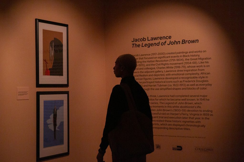 A gentleman admires pieces from Jacob Lawrence’s The Legend of John Brown collection at the Lowe Art Museum’s After Hours Exhibit on Thursday, Feb. 24.
