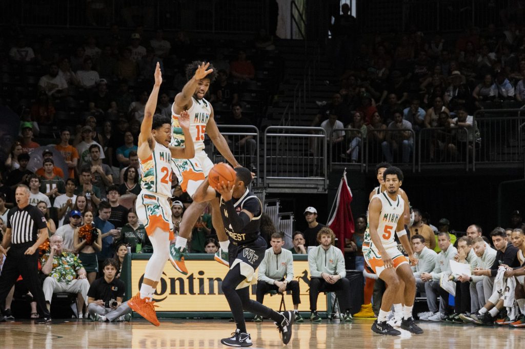 Third-year sophomore guard Nijel Pack and third-year sophomore forward Norchad Omier block a Wake Forest guard in Miami’s game against Wake Forest at the Watsco Center on Saturday, Feb. 18.