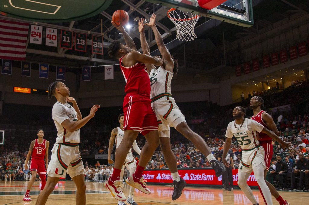 Third-year sophomore forward Norchad Omier blocks a Louisville forward in the second half of Miami’s game against the Cardinals at the Watsco Center on Saturday, Feb. 11.