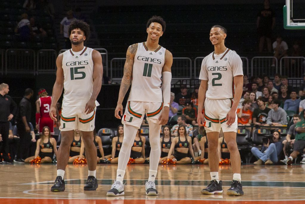 Norchad Omier, Jordan Miller and Isaiah Wong look comfortable during the final minuets of Miami’s win over the University Louisville on Saturday, Feb. 11 at the Watsco Center.