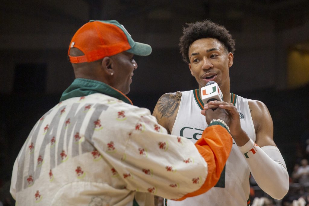 Fifth-year senior guard Jordan Miller talks with host Uptown Dale following Miami's 93-85 win over the University of Louisville on Saturday, Feb. 11 at the Watsco Center.