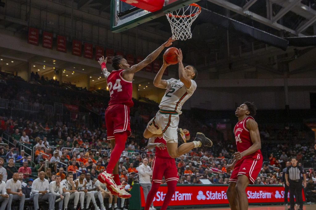 Guard Isaiah Wong shoots a contested layup against Louisville on Feb. 11 at the Watsco Center.