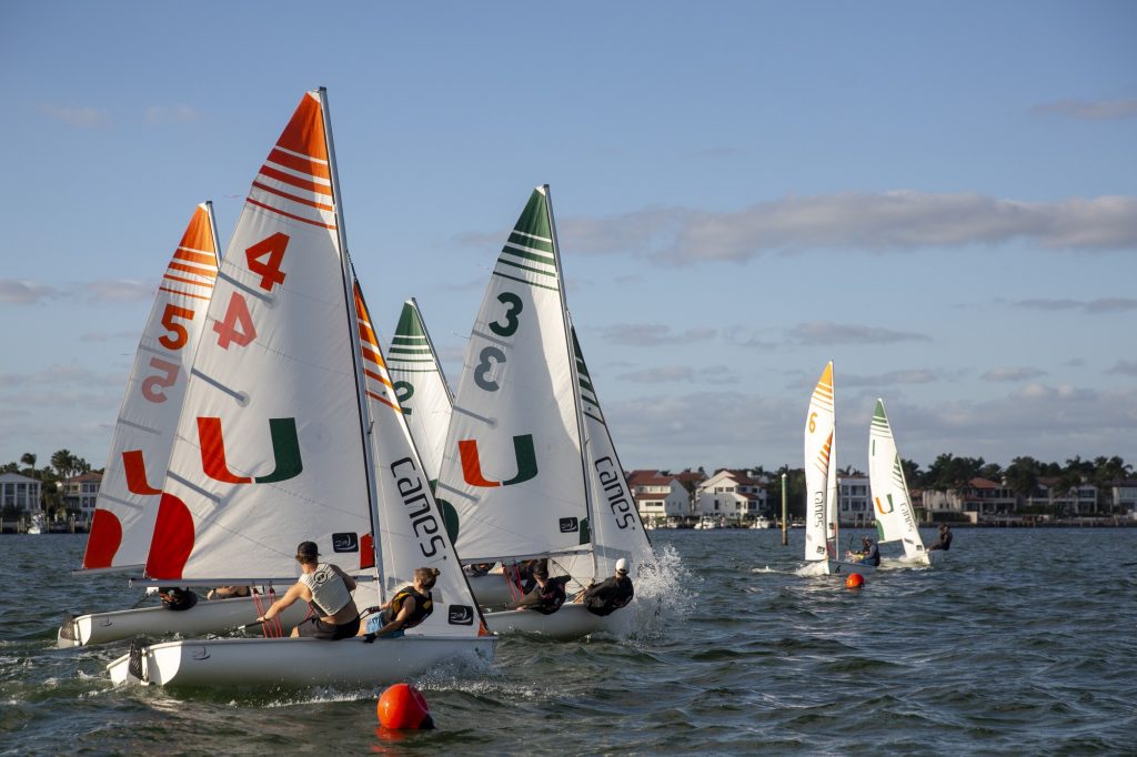 'Canes sailing green and orange teams race across the start line during a practice race during training in Biscayne Bay on Tuesday, Feb. 7.