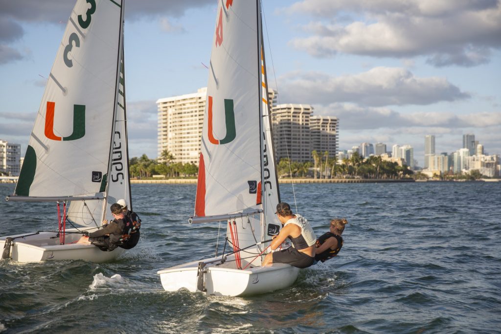 Team orange and team green lean off their boats during an afternoon practice in Biscayne Bay on Tuesday, Feb. 7.