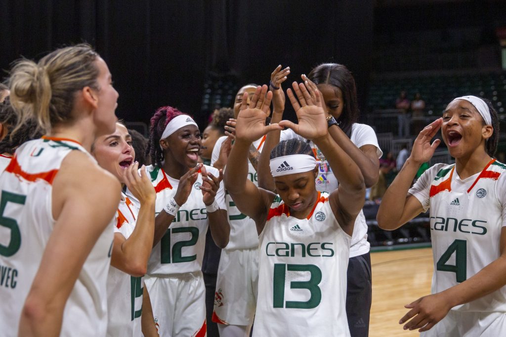 Sophomore guard Lashae Dwyer throws up “The U” as The Canes celebrate their 86-82 win against FSU on Thursday, Feb. 9 in the Watsco Center.