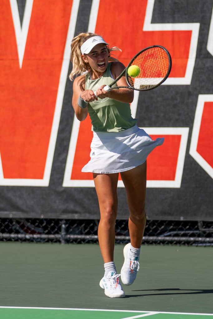 Junior Isabella Pfennig returns the ball during the eighth game of the second set her singles match at the Neil Schiff Tennis Center on Feb. 11, 2023.