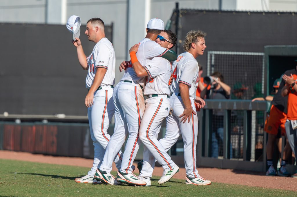 Sophomore outfielder Edgardo Villegas celebrates with teammates after Miami's win against Penn State University on Sunday, Feb. 19 at Mark Light Field.