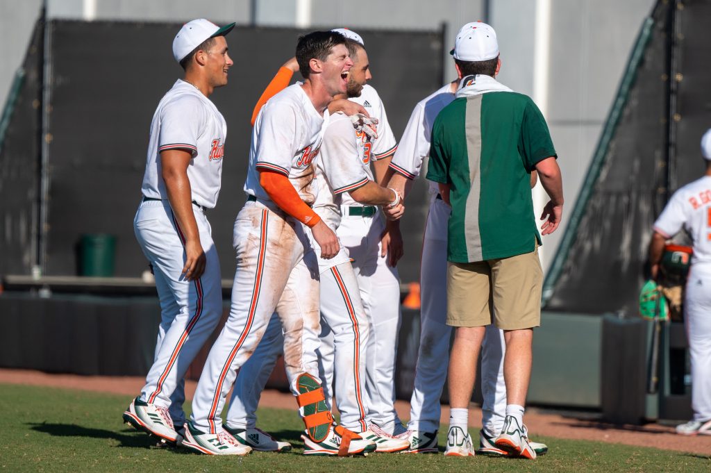 Junior outfielder Zach Levenson laughs with teammate CJ Kayfus following Miami's win over Penn State University on Sunday, Feb. 19 at Mark Light Field.