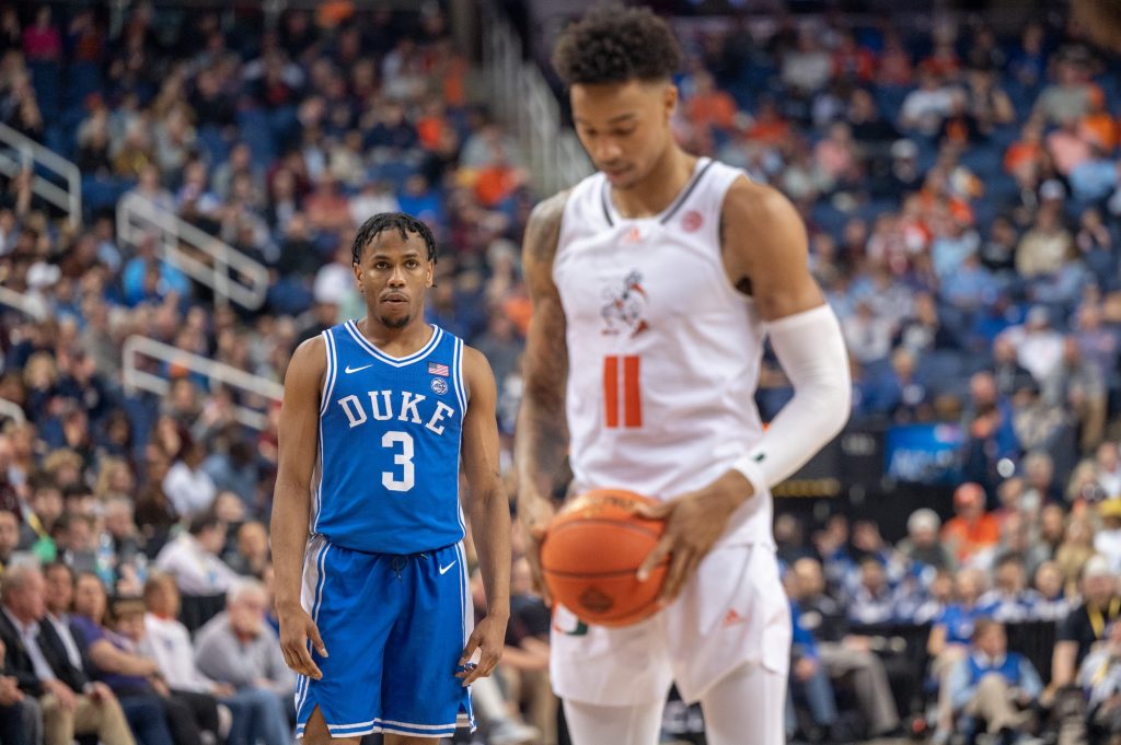 Duke gaurd Jeremy Roach looks on as fifth-year senior guard Jordan Miller prepares to throw a free throw during Miami's loss on March 10 at the Greensboro Coliseum Complex.