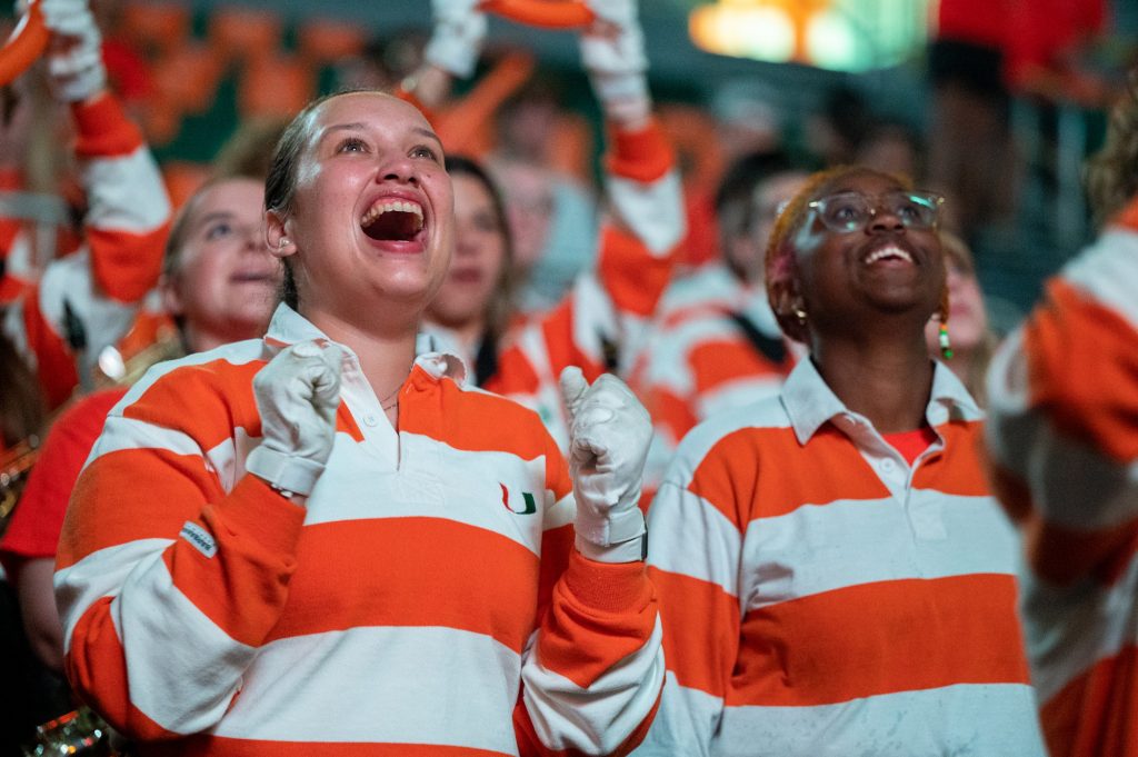 Juniors Stefania Papadopulos and Ava Harris cheer on the 'Canes during their game against Florida State University on Saturday, Feb. 25 at the Watsco Center.