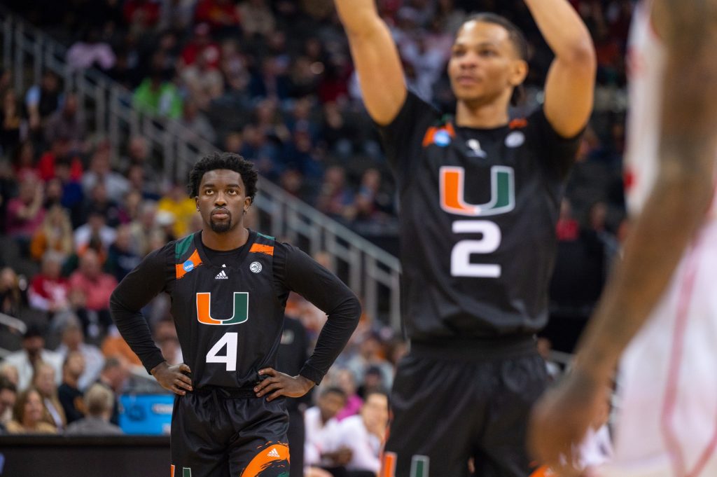 Sophomore guard Bensley Joseph watches on as fourth-year junior guard Isaiah Wong shoots a free-throw during the first half of Miami's Sweet 16 matchup against the Unviersity of Houston on Friday, March 24 at the T-Mobile Arena.