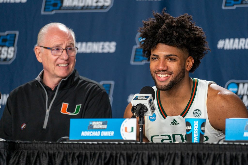 Third-year sophomore forward Norchad Omier smiles while answering a question during Miami’s press conference after their 63-56 win over Drake University in the MVP Arena in Albany, NY on March 17, 2023.