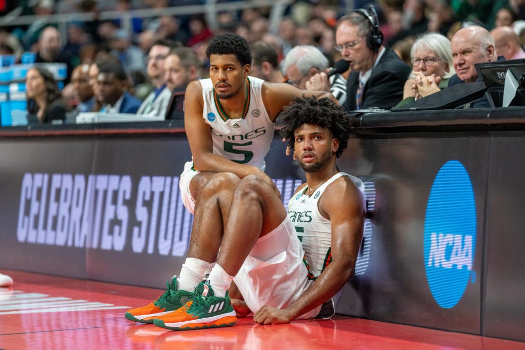 Fourth-year junior guard Harlond Beverly and third-year sophomore forward Norchad Omier wait to check in to the game during the second half of Miami’s Round of 64 matchup against Drake University in MVP Arena in Albany, N.Y. on March 17, 2023.
