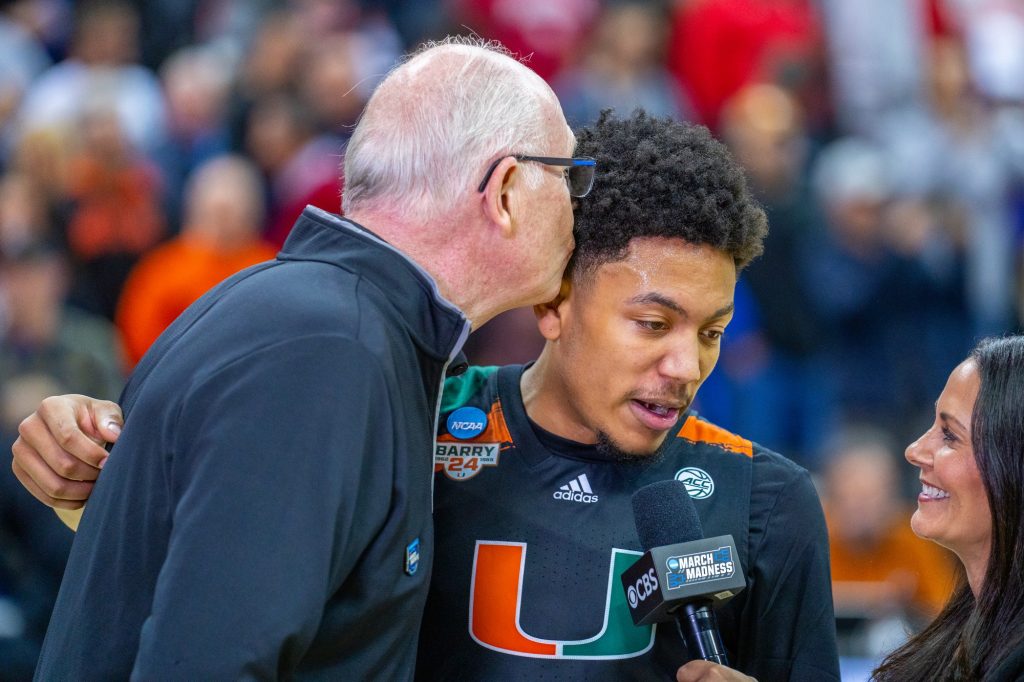 Head coach Jim Larrañaga kisses third-year sophomore guard Nijel Pack during a TV interview after Miami’s 89-75 Sweet 16 win over the University of Houston in the T-Mobile Center in Kansas City, MO on March 24, 2023.