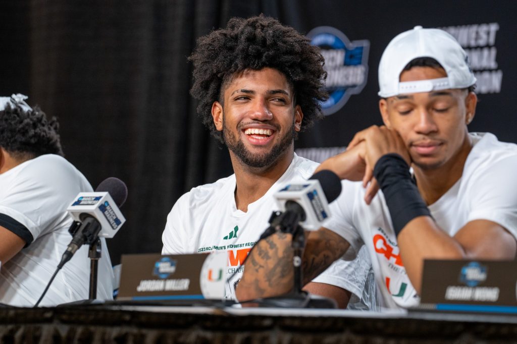 Third-year sophomore forward Norchad Omier smiles during head coach Jim Larrañaga’s answer after Miami’s 88-81 Elite Eight win over the University of Texas in the T-Mobile Center in Kansas City, MO on March 26, 2023.
