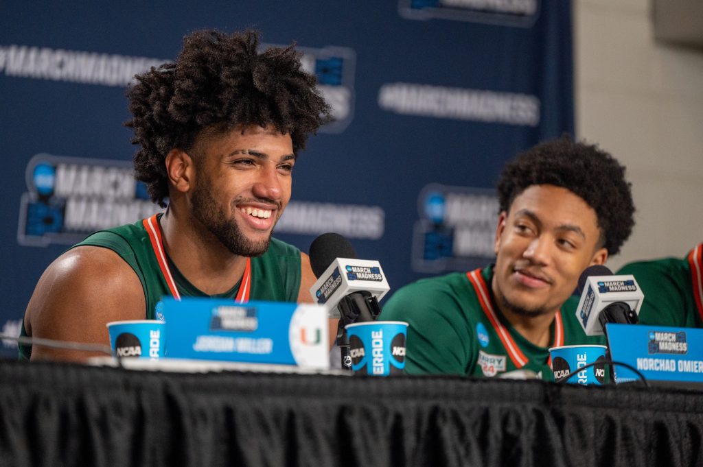 Third-year sophomore forward Norchad Omier laughs during the press conference following Miami's Round of 32 win over Indiana University on Sunday, March 19 at the MVP Arena.