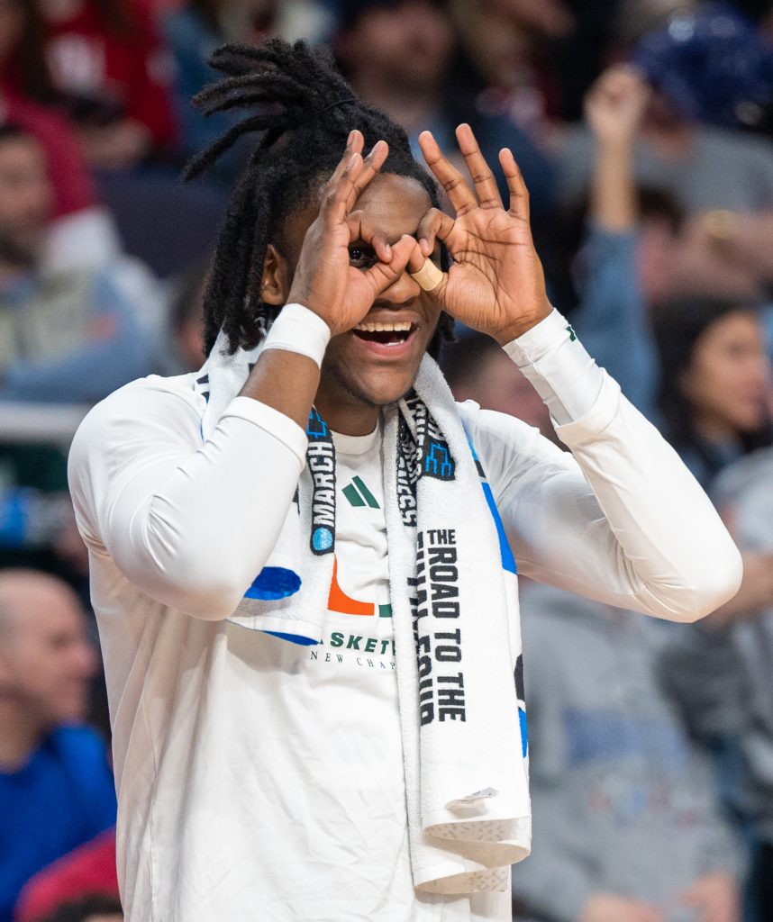 Freshman guard Christian Watson reacts to a three-pointer from the bench during the second half of Miami's Round of 32 game against Indiana University on Sunday, March 19 at the MVP Arena.