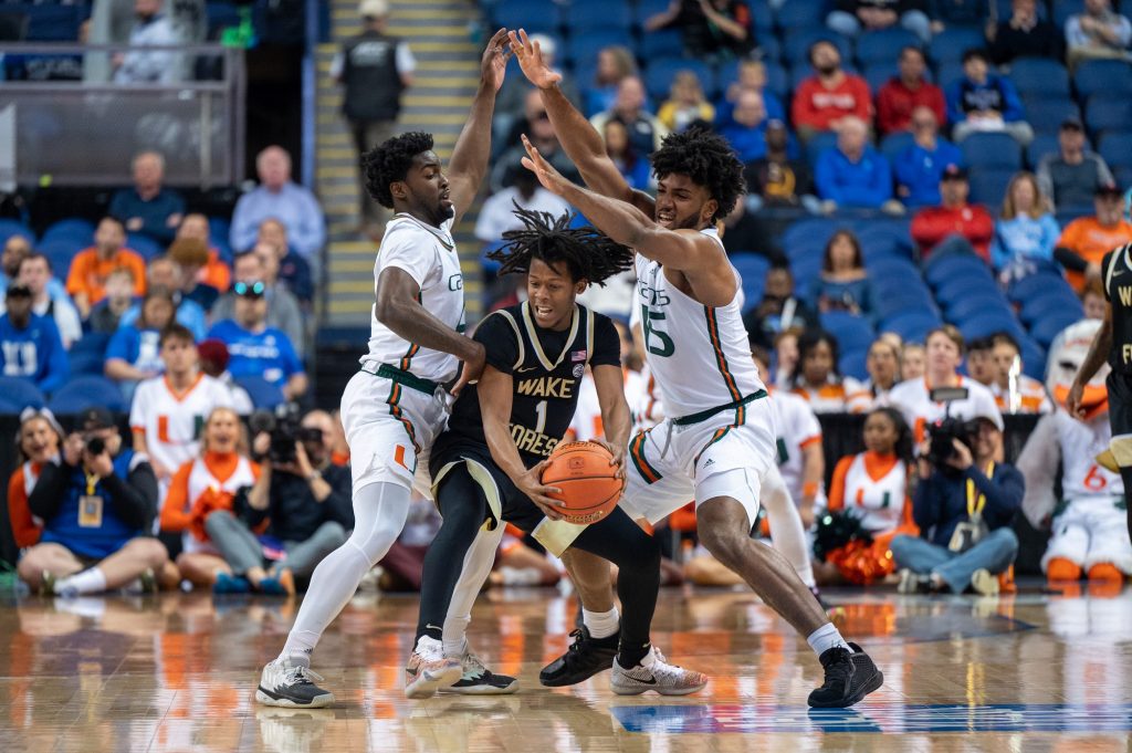 Bensley Joseph and Norchad Omier block Tyree Appleby of Wake Forest University during the quarterfinals of the ACC Tournament on Thursday, March 9 at the Greensboro Coliseum Complex.