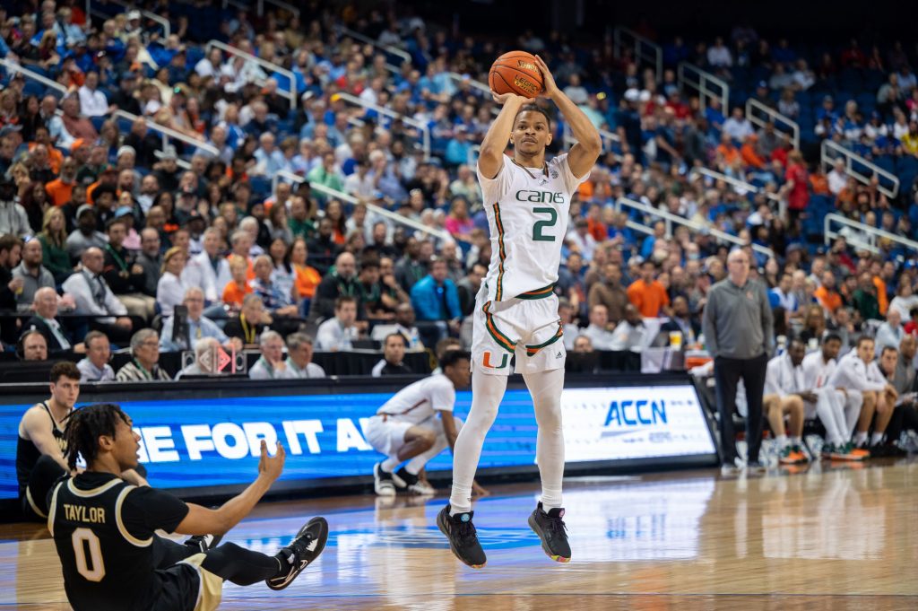 Fourth-year junior guard Isaiah Wong shoots a three during Miami's win over Wake Forest University on Thursday, March 9 at the Greensboro Coliseum Complex.