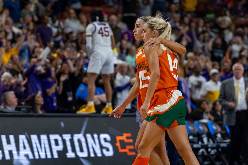 Haley and Hanna Cavinder walk off the court together after falling to LSU in Miami’s first ever Elite Eight matchup in the Bon Secours Arena on Sunday, March 26.