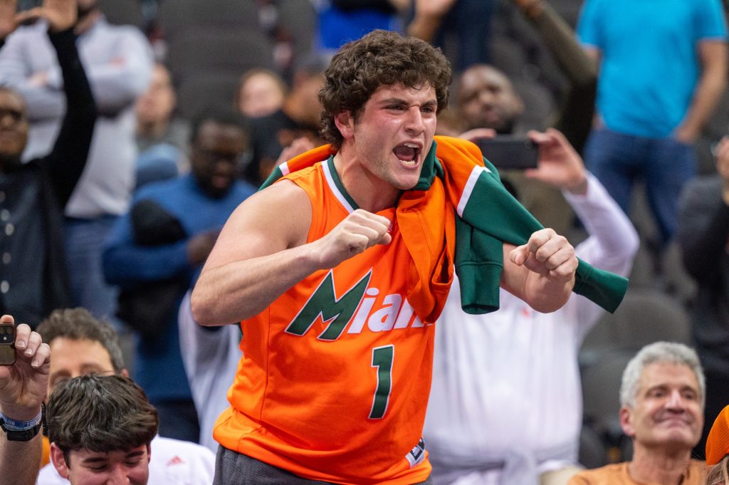 A Miami fan yells to players on the court following Miami's Elite Eight win over the University of Texas on Sunday, March 26 at the T-Mobile Center.