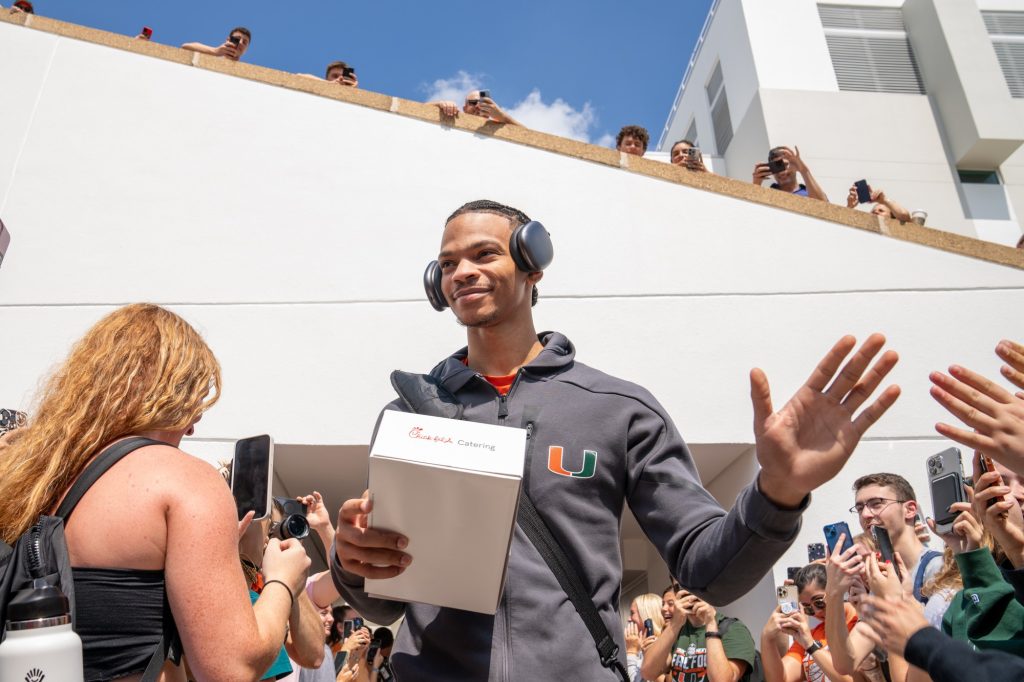Fourth-year junior guard Isaiah Wong greets fans as he walks to the team bus outside of the Watsco Center during the Miami Final Four Sendoff on March 29, 2023.