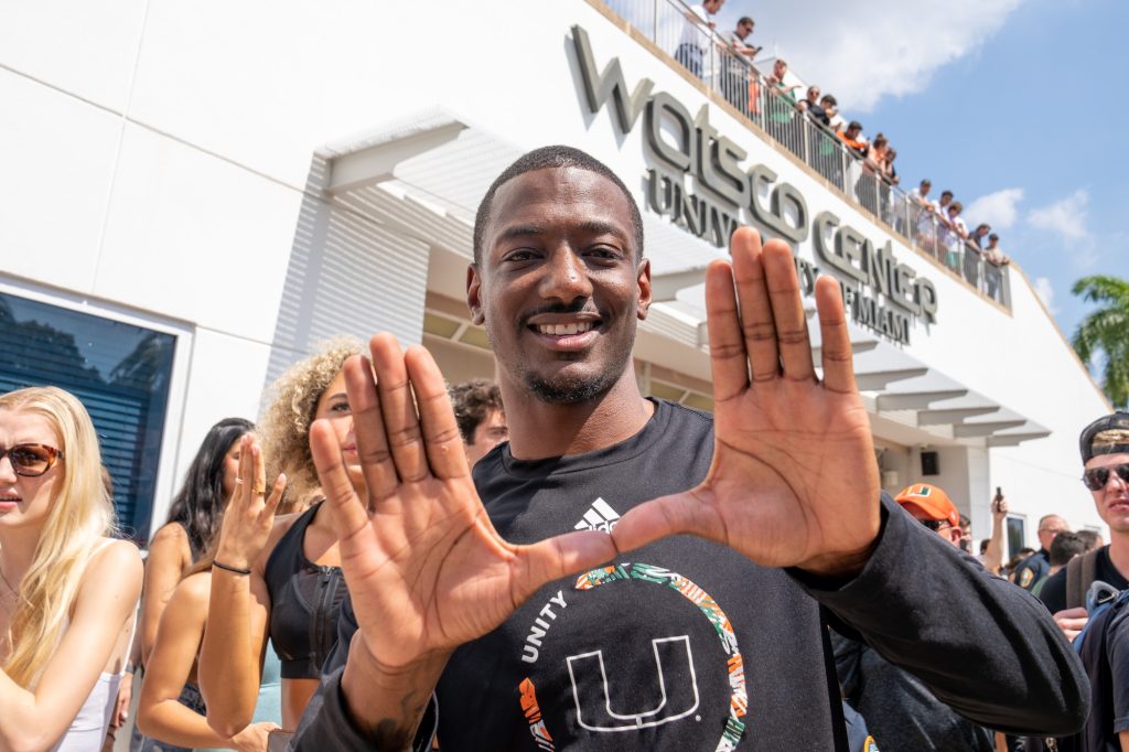 Defensive backs coach DeMarcus VanDyke throws up the U outside of the Watsco Center during the Miami Final Four Sendoff on March 29, 2023.