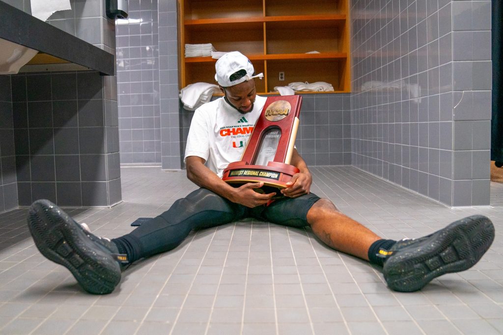 Sophomore guard Wooga Poplar cradles the NCAA Midwest Regional Championship Trophy after Miami’s 88-81 Elite Eight win over the University of Texas in the T-Mobile Center in Kansas City, MO on March 26, 2023.
