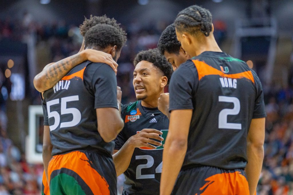 Miami players huddle during the second half of Miami’s Elite Eight matchup against the University of Texas in the T-Mobile Center in Kansas City, MO on March 26, 2023.