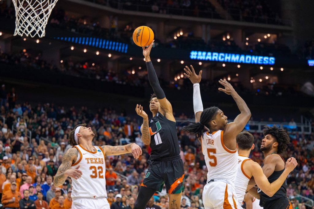 Fifth-year senior guard Jordan Miller shoots the ball during Miami's Elight Eight matchup against the University of Texas on Sunday, March 26 at the T-Mobile Center.