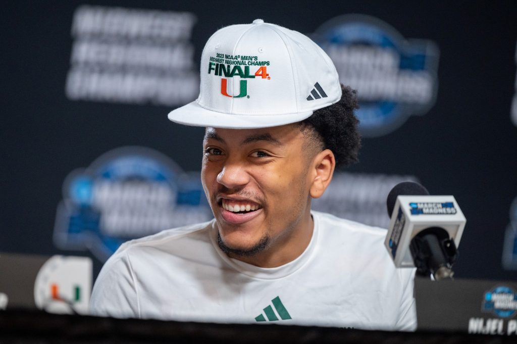 Third-year sophomore guard Nijel Pack laughs at an answer given by teammate Norchad Omier during the press conference following Miami's Elite Eight win over Texas on Sunday, March 26 at the T-Mobile Center.