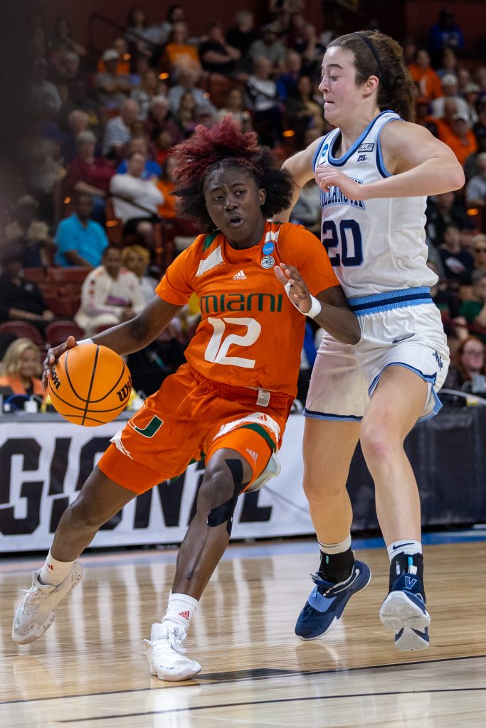 Sophomore guard Ja’Leah Williams drives the ball past Villanova star Maddy Siegrist in the first quarter of Miami’s Sweet Sixteen matchup against Villanova in the Bon Secours Wellness Arena on Friday, Mar. 24.