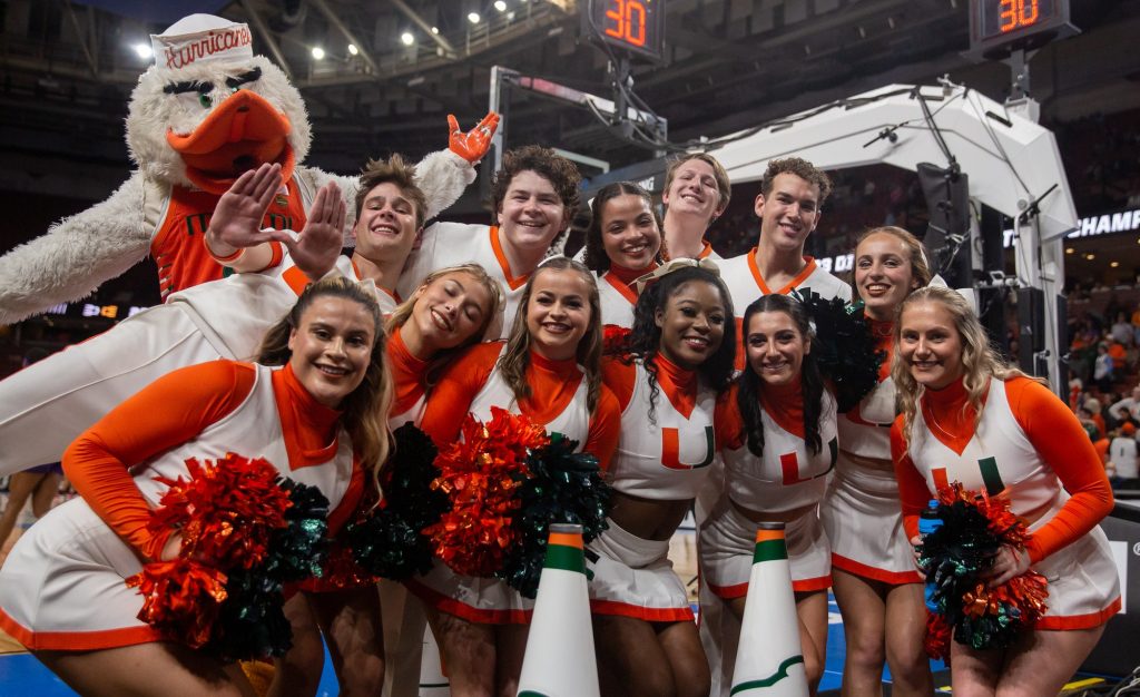 University of Miami’s cheerleaders pose with Sebastian prior to the 'Canes Sweet Sixteen matchup against the Villanova Wildcats in the Bon Secours Arena on Friday, Mar. 24.