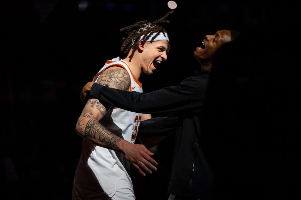 Senior forward Christian Bishop from the University of Texas celebrates during player introductions prior to Miami's Elite Eight matchup on Sunday, March 26 at the T-Mobile Center.