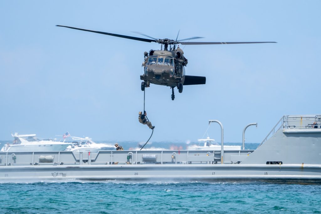 Soldiers of the U.S. Army’s Seventh Special Forces Group fast rope from a UH-60 Black Hawk to the USAV Monterrey during the Hyundai Air and Sea Show at Miami Beach on May 28, 2023.