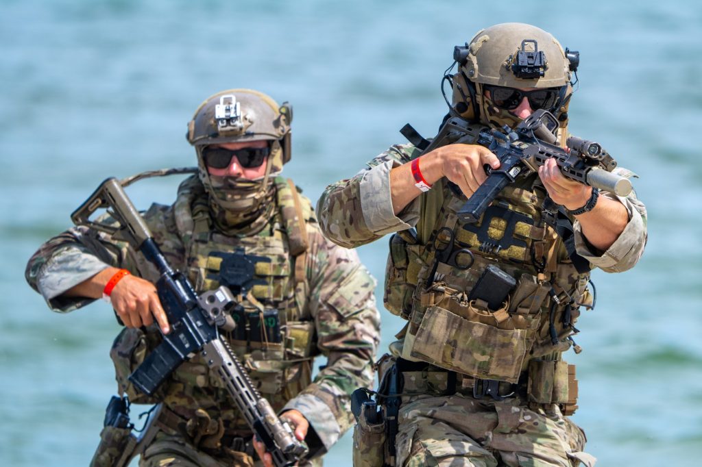 Soldiers of the U.S. Army’s Seventh Special Forces Group advance on the beach during a demonstration at the Hyundai Air and Sea Show at Miami Beach on May 28, 2023. The soldiers used blank rounds to simulate capturing a hostile-held point.