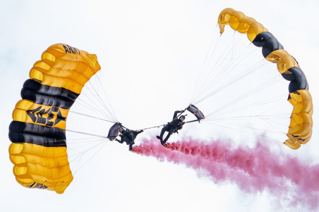Members of the U.S. Army Parachute Team’s Black Demonstration Team perform a down-plane maneuver over the Hyundai Air and Sea Show at Miami Beach on May 27, 2023.