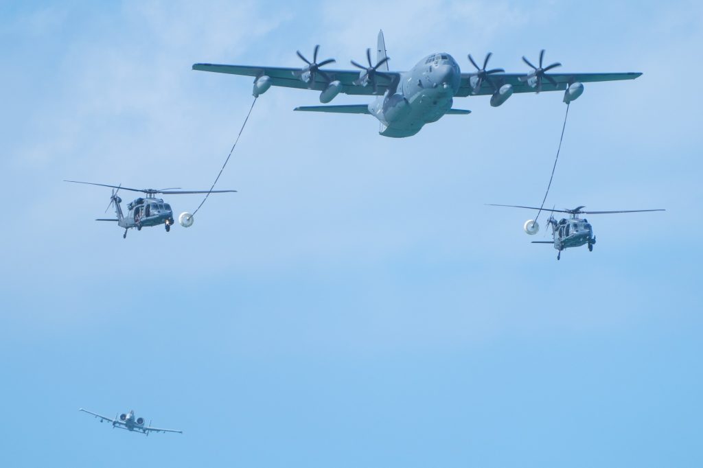 A HC-130J demonstrates its refueling capabilities as it extends its fuel lines to two HH-60 Pave Hawk Helicopters as an A-10 circles during the 920th Rescue Wing demonstration at the Hyundai Air and Sea Show at Miami Beach on May 27, 2023.
