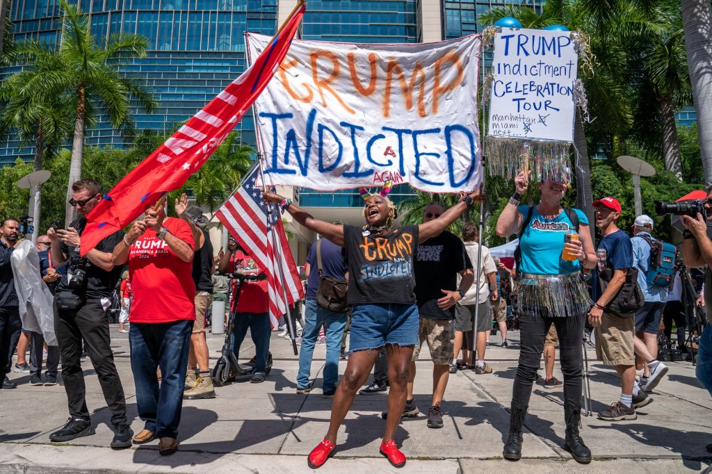 Trump critics and supporters gather outside of the Wilkie D. Ferguson Jr. United States Courthouse prior to the former president’s indictment on June 13, 2023.