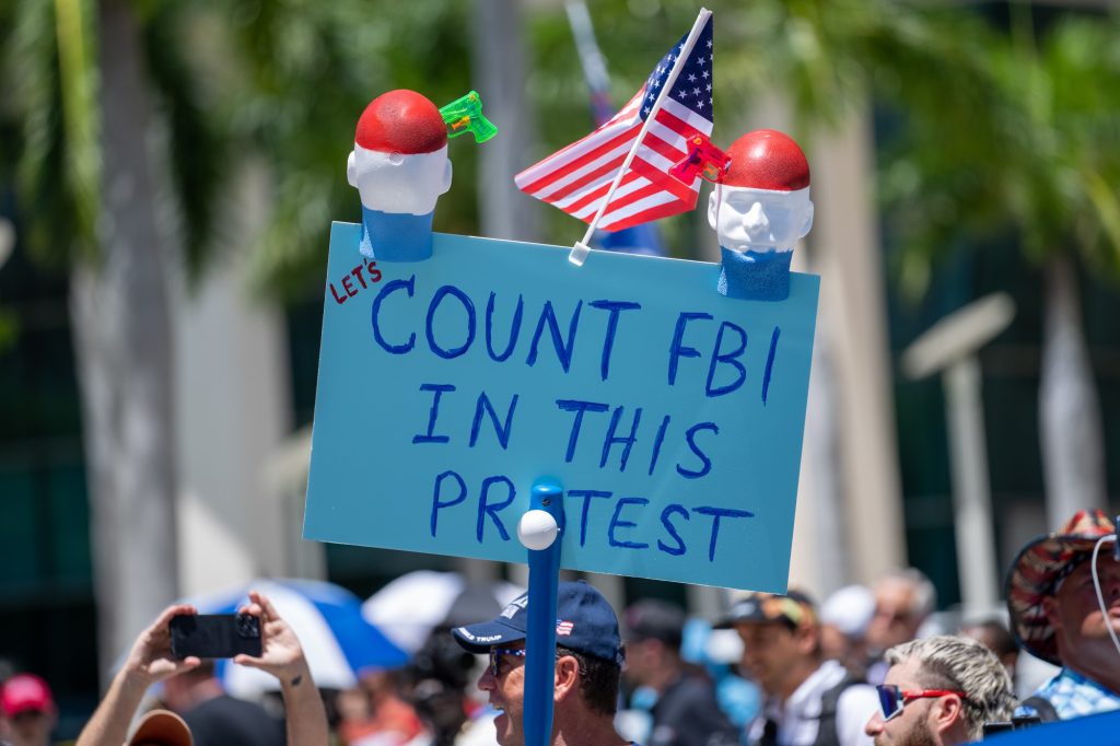 A protester insinuates undercover federal agent presence while showing support for former President Trump outside of the Wilkie D. Ferguson Jr. United States Courthouse during his indictment on June 13, 2023.