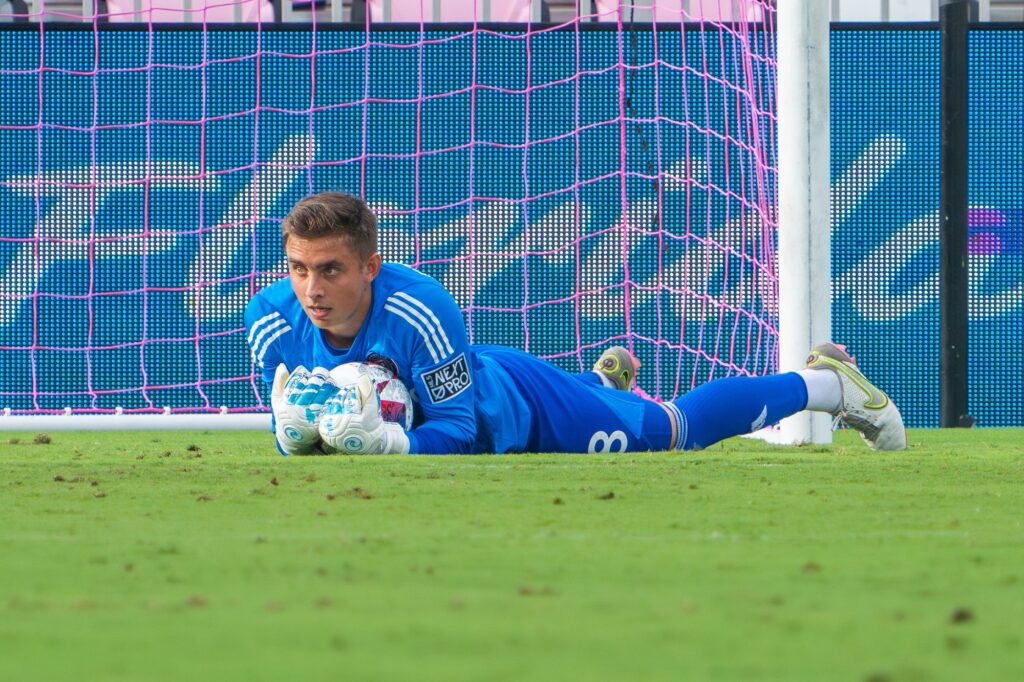 Goalkeeper Owen Finnerty covers the ball after making a stop during the first half of Inter Miami CF II’s match versus Crown Legacy FC at DRV PNK Stadium on Aug. 19, 2023.