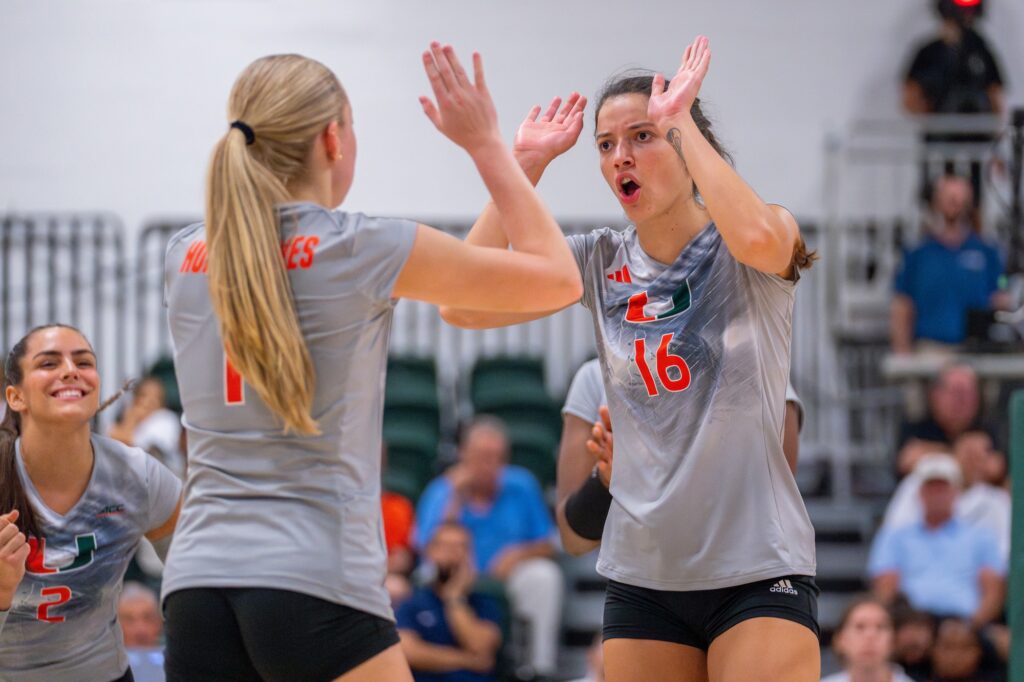 Graduate student middle blocker Abby Casiano and fifth-year setter Savannah Vach celebrate winning a point during the second set of Miami’s match versus Florida Atlantic University in the Knight Sports Complex on Aug. 28, 2023.