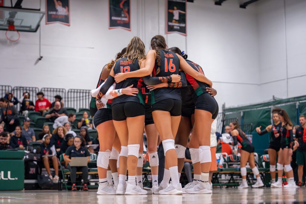 ‘Canes volleyball players huddle up before Miami’s match versus Maryland in the Knight Sports Complex on Aug. 25, 2023.