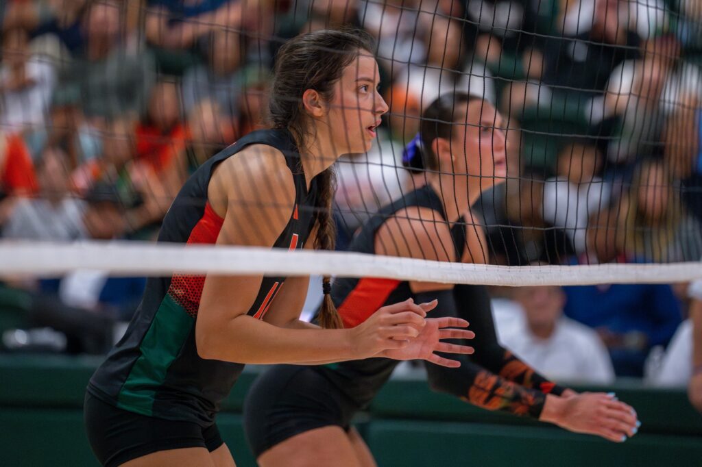 Graduate student middle blocker and redshirt senior outside hitter Angela Grieve wait for the serve during the second set of Miami’s match versus Maryland in the Knight Sports Complex on Aug. 25, 2023.