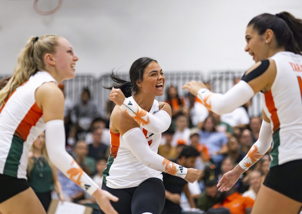 credit: Alexandra Fisher // Junior defensive specialist Yaidaliz Rosado yells in celebration with her teammates after winning a point in UM's game against FIU on August 26, 2023.