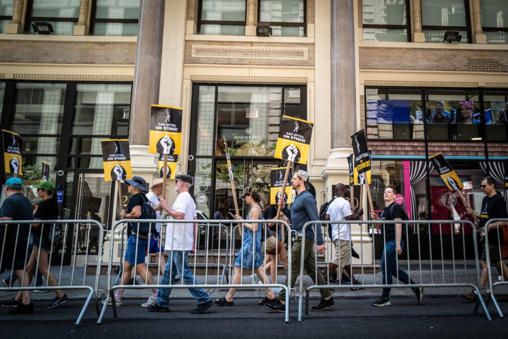 In New York City, SAG-AFTRA protesters march in front of the Warner Brothers offices in Manhattan.