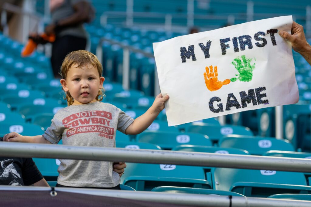 A new ‘Canes fan holds up a sign before Miami’s game versus Bethune Cookman at Hard Rock Stadium on Sept. 14, 2023.