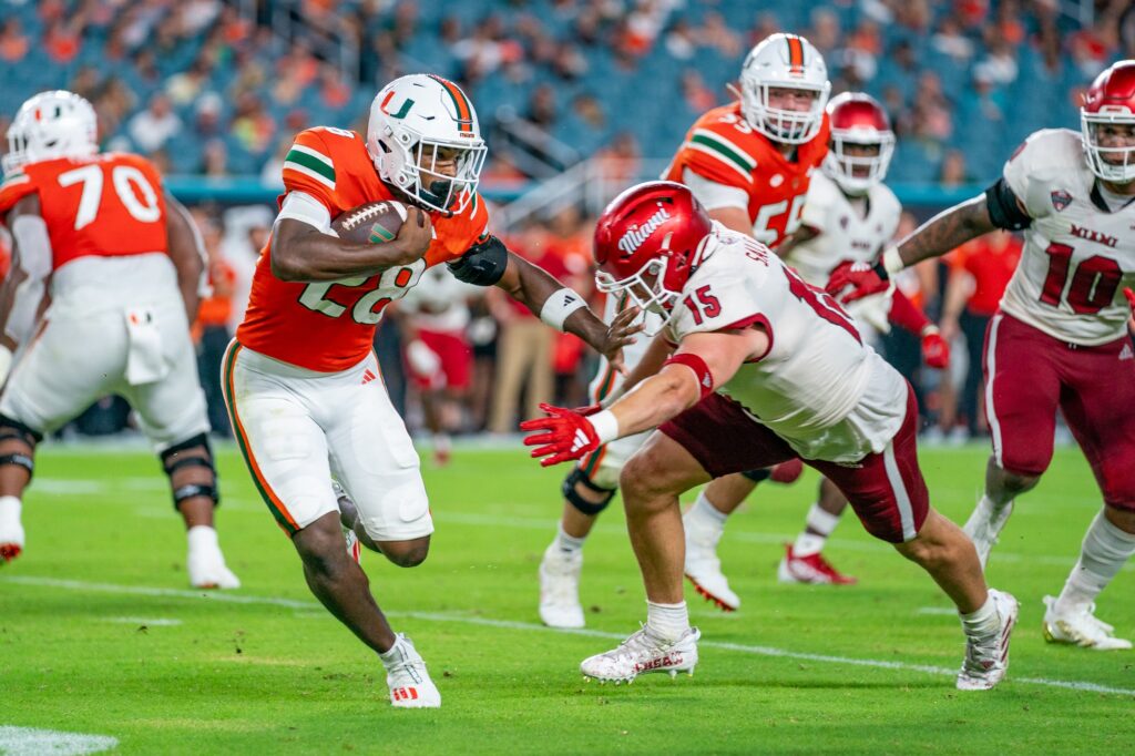Redshirt freshman running back Ajay Allen stiff-arms a defender during the second quarter of Miami’s game versus Miami (OH) at Hard Rock Stadium on Sept. 1, 2023.