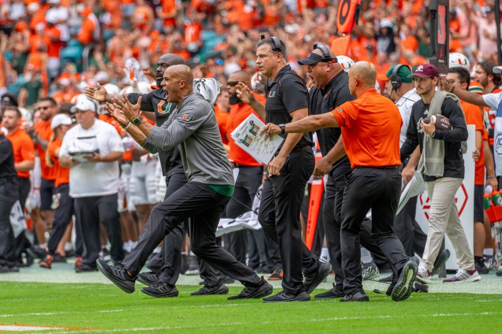 The ‘Canes coaching staff takes the field after a play in the first quarter of Miami’s game versus Texas A&M at Hard Rock Stadium on Sept. 9, 2023.